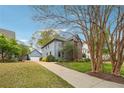 Charming home featuring a brick facade, blue siding, mature trees, and a well-manicured lawn at 108 Kirk Crossing Dr, Decatur, GA 30030