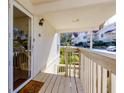 Inviting covered porch with wood floors, a glass door, and a view of the street at 207 Bridge Se Ln, Smyrna, GA 30082