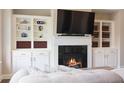 Cozy living room featuring a fireplace, built-in shelving, and comfortable seating at 308 Overture Ct, Smyrna, GA 30080
