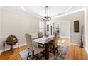 Inviting dining room with hardwood floors, tray ceiling, chandelier, and natural light at 3285 Millwood Se Trl, Smyrna, GA 30080