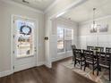 Formal dining area with stylish lighting fixture and hardwood floors, perfect for entertaining at 11620 Crestview Ter, Johns Creek, GA 30024
