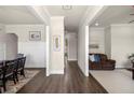 Hallway featuring beautiful trim work and hardwood flooring with views into the living and dining rooms at 11620 Crestview Ter, Johns Creek, GA 30024