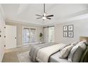 Main bedroom featuring a tray ceiling, ceiling fan, and ensuite bathroom at 1431 Brandy Shoals Se Ct, Conyers, GA 30013