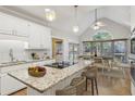 Bright, open kitchen featuring a large island with granite countertops and a dining area with backyard views at 1431 Brandy Shoals Se Ct, Conyers, GA 30013
