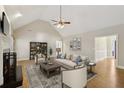 Spacious living room with vaulted ceilings, fireplace, hardwood floors, and neutral decor at 1431 Brandy Shoals Se Ct, Conyers, GA 30013