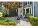 Inviting front entrance with Adirondack chairs and a charming, decorative tree at 1904 Woodland Hills Nw Ave, Atlanta, GA 30318