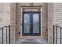 Inviting home entryway featuring double doors with decorative glass inserts and a 'Welcome' mat at 3365 Preservation Cir, Lilburn, GA 30047