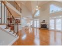 Bright living room with fireplace, high ceilings, large windows, and hardwood floors at 3365 Preservation Cir, Lilburn, GA 30047
