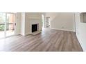 Spacious living room with fireplace, hardwood floors, and sliding door access to the deck at 5360 Brooke Ridge Dr, Dunwoody, GA 30338