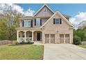 Inviting two-story home with a blend of brick and siding, and a covered front porch at 105 Oakfield Way, Douglasville, GA 30134