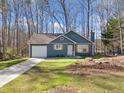 Inviting single-Gathering home with blue siding, attached garage, and well-manicured lawn on a sunny day at 109 Beaver Dam Rd, Peachtree City, GA 30269