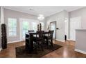 Bright dining area features modern light fixture, wood floors, and neutral wall paint at 1731 Pryor Sw Rd # 108, Atlanta, GA 30315