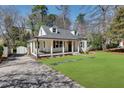 Quaint home with a covered porch and dormer windows and long driveway at 1861 Dyer Cir, Atlanta, GA 30341
