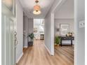 Bright entryway featuring hardwood floors, a modern light fixture and leading to the kitchen at 4519 Glenforest Ne Dr, Roswell, GA 30075