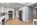 Bright kitchen with stainless steel appliances, white cabinets, and designer backsplash at 4519 Glenforest Ne Dr, Roswell, GA 30075