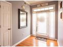 Welcoming entryway features hardwood floors, natural light, and a stylish mirror to enhance the home's appeal at 531 Lindsey Way, Social Circle, GA 30025
