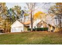 Inviting single-Gathering home with a two-car garage, complemented by a lush green lawn and mature trees at 531 Lindsey Way, Social Circle, GA 30025