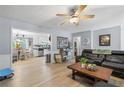 Open-concept living area with hardwood floors, seamlessly connecting the living room and kitchen at 615 Upland Nw Trl, Conyers, GA 30012