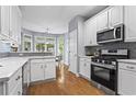 Bright kitchen with white cabinets, stainless steel appliances, and hardwood floors at 2462 Chestnut Lndg, Atlanta, GA 30360