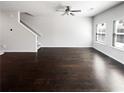 Spacious living room with dark wood floors, neutral walls and lots of natural light at 7109 Gladstone Cir, Lithonia, GA 30038