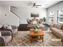 Bright, open-concept living room with stylish furnishings, ceiling fan, and abundant natural light at 7109 Gladstone Cir, Lithonia, GA 30038