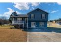 Inviting two-story home featuring a cozy front porch, ample parking, and a well-maintained lawn at 170 Cobblestone Ct, Douglasville, GA 30134
