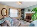 Comfortable living room with a fireplace, plush seating, and natural light from the window at 170 Cobblestone Ct, Douglasville, GA 30134