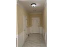 Well-lit foyer features tile flooring, white wainscoting, and a white front door at 3259 S Pointe Ct, Atlanta, GA 30340