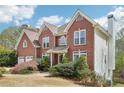 Charming two-story brick home with a two-car garage and a well-manicured lawn at 2138 Bramlett Nw Pl, Marietta, GA 30064