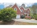 Two-story brick home with a well-manicured lawn and tree at 2138 Bramlett Nw Pl, Marietta, GA 30064