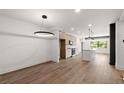 Living room featuring hardwood floors, neutral paint, and modern lighting at 108 Park Place Unit 104, Decatur, GA 30030