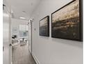 Hallway with hardwood floors, modern paintings, and natural light coming through the window at 108 Park Place Unit 304, Decatur, GA 30030