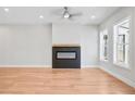 Bright living room with a modern fireplace, ceiling fan, and view of the outdoor at 2572 Silver Star Ne Dr, Marietta, GA 30066