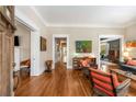 Open concept living space with hardwood floors, multiple seating areas, and seamless flow between rooms at 637 Linwood Ne Ave, Atlanta, GA 30306