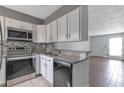 Well-lit kitchen with stainless steel appliances and easy access to living area at 6691 Colchester Pl, Norcross, GA 30093