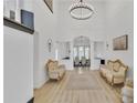 Bright foyer featuring chandelier lighting, high ceilings and luxury vinyl plank flooring at 1055 Crabapple Parc Dr, Roswell, GA 30076