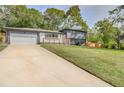Stylish two-story home featuring a lush green lawn and long driveway at 2344 Belmont Dr, Decatur, GA 30032