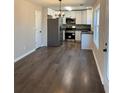 Modern kitchen with stainless steel appliances, white cabinets, and granite countertops at 95 Kendall Ln, Covington, GA 30014