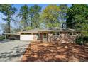 Charming brick ranch home with a carport and well-maintained front yard at 3712 Spring Hill Se Rd, Smyrna, GA 30080