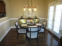 Cozy dining area featuring a modern light fixture, stylish furniture, and access to the outdoors at 11 Reese Way # 11, Avondale Estates, GA 30002
