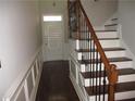Elegant foyer with hardwood floors, decorative molding, and staircase with ornamental iron railings at 11 Reese Way # 11, Avondale Estates, GA 30002
