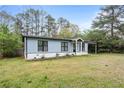 Lovely one-story home featuring a light blue exterior, black trim, and well-kept lawn at 1601 Sycamore Nw Dr, Kennesaw, GA 30152