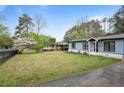 A charming one-story home with an attached carport and a lovely front yard at 1601 Sycamore Nw Dr, Kennesaw, GA 30152