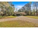 Charming single-story home featuring a two-car garage and a concrete driveway at 4670 Sundridge Trl, Fairburn, GA 30213