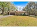 Charming single-story home featuring a two-car garage and a well-maintained front lawn at 4670 Sundridge Trl, Fairburn, GA 30213