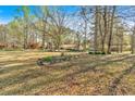 Landscaped front yard with mature trees offering shade and privacy to the home at 4670 Sundridge Trl, Fairburn, GA 30213