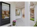 Inviting front porch showcasing a black front door and a glimpse of the outdoor seating area at 1922 Coal Pl, Atlanta, GA 30318