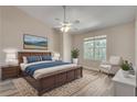 Spacious main bedroom with a large window, ceiling fan and ensuite bathroom at 2306 Queen Anne Ct, Atlanta, GA 30350