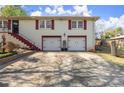 Attractive two-story home with white brick, red trim, two-car garage, and a paved driveway at 945 Blackwell Rd, Marietta, GA 30066