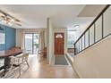 Open dining room with a view of the staircase and an entrance to the front door at 664 Powers Ferry North Se, Marietta, GA 30067